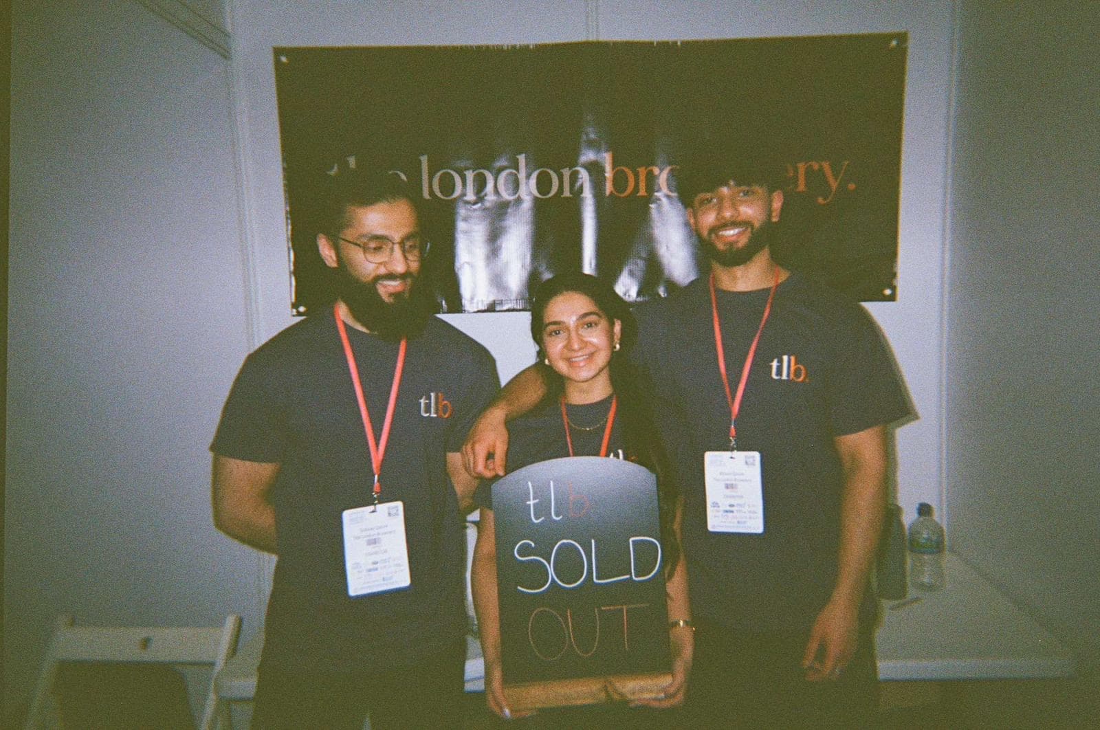 a polaroid shot of the 3 sibling owners of the london brownery after they sold out at their first event