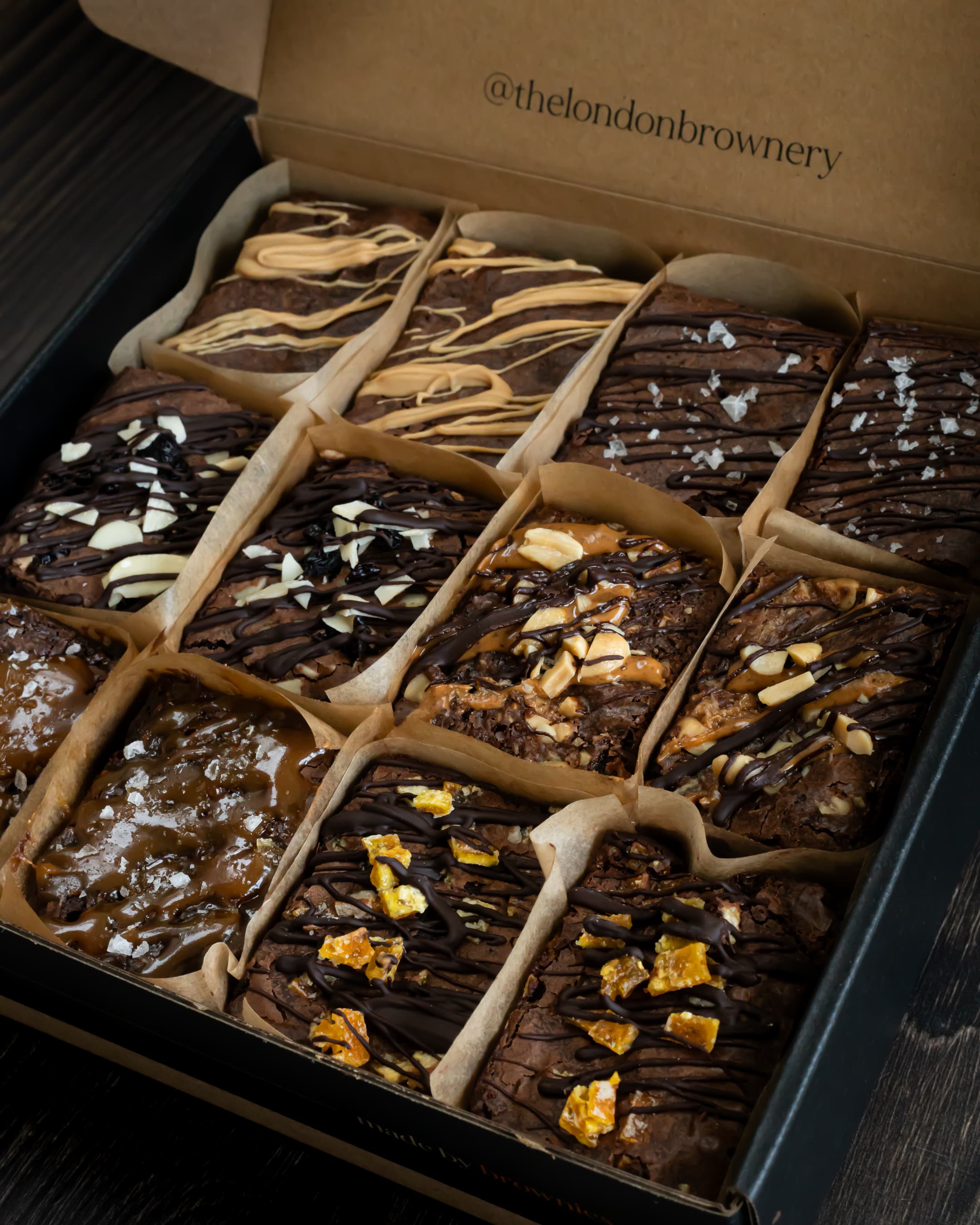 a box of six different flavoured brownies: masala chai, classic chocolate, cherry and almond, peanut butter, salted caramel, chocolate orange