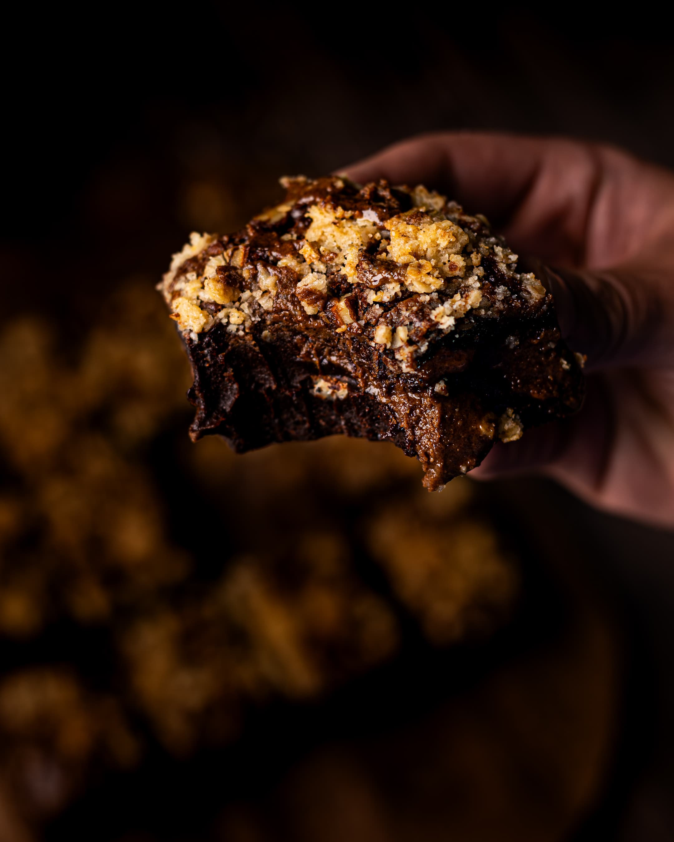 pecan crumble brownie with bite taken out of it 